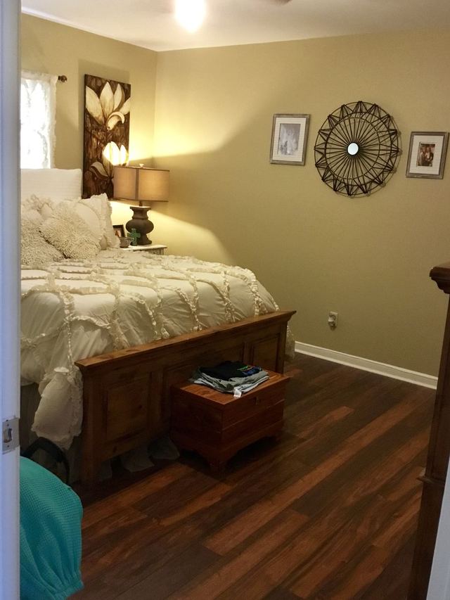 Decorated bedroom in Unit 207 with bed and nightstand — furniture not included