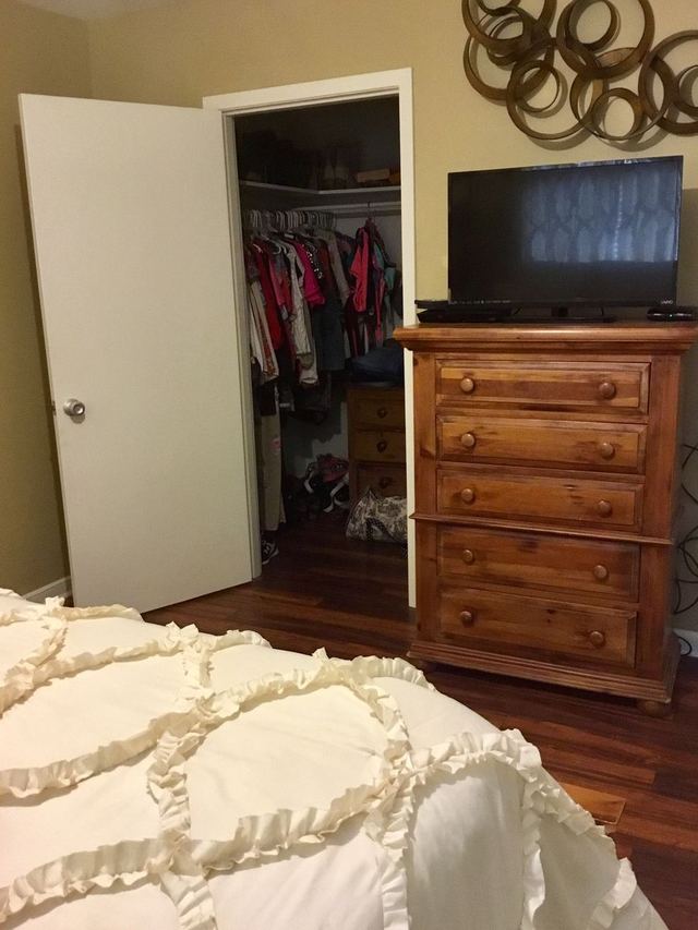 Decorated bedroom in Unit 207 with dresser and closet — furniture not included