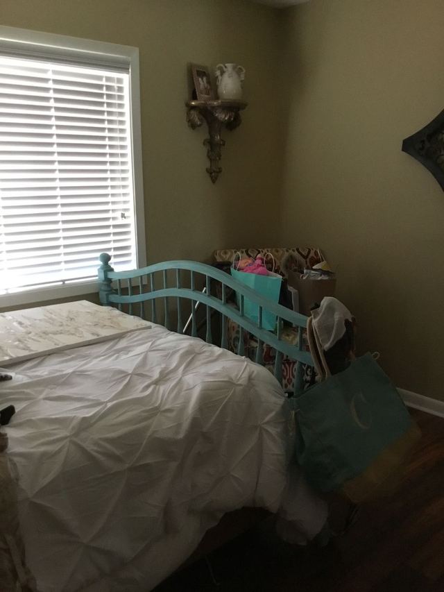 Decorated bedroom in Unit 207 with wood-look flooring — furniture not included